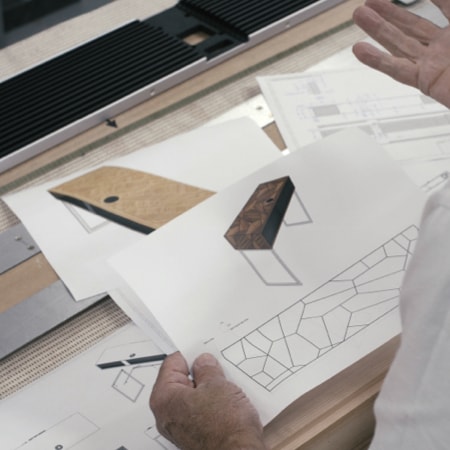 Craftsman holding Ruark R5 MiE’s cabinet
