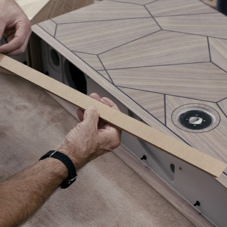 Hand holding a screwdriver, working on Ruark R5 MiE